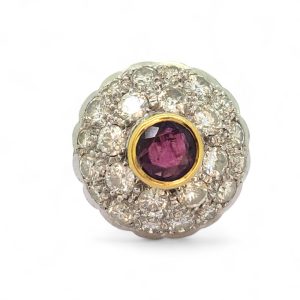 Ruby and Diamond Bombe Cluster Ring, central red ruby sits atop a domed bombe cluster of sparkling diamonds in white gold to an 18ct yellow gold shank with decorative scrolled shoulders