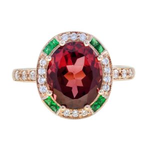 3.88ct Oval Rubellite Emerald Diamond Cluster Engagement Ring, 3.88ct oval red tourmaline surrounded by a halo of diamonds with emerald accents in 14ct rose gold