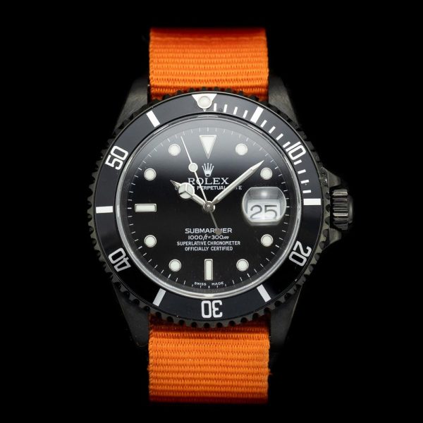 Rolex Submariner Stealth 16610 Black DLC Dial and Orange Strap, 40mm case has been customised with a black diamond like coating and fitted to orange NATO strap