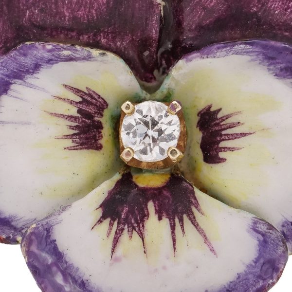 Gold flower brooch with enamel and an old-European cut diamond.