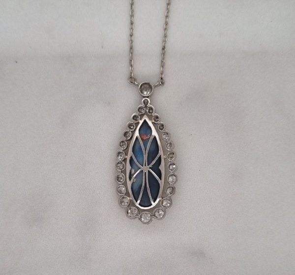 A vintage art deco pear shaped opal pendant surrounded by twenty six diamonds of approximately 1 carat.