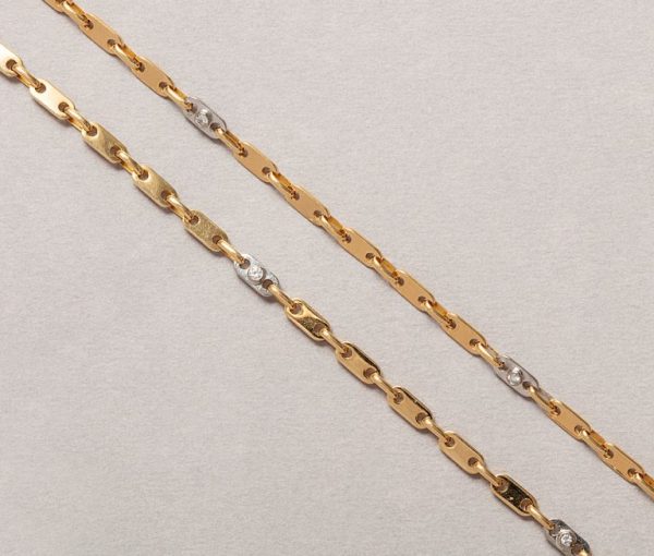 Modern Cartier 18ct yellow and white gold chain necklace with twelve small brilliant cut diamonds.