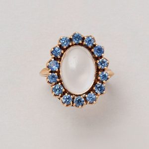 Vintage 14ct rose gold cluster ring with moonstone cabochon bezel set in prong setting surrounded by brilliant cut sapphires.