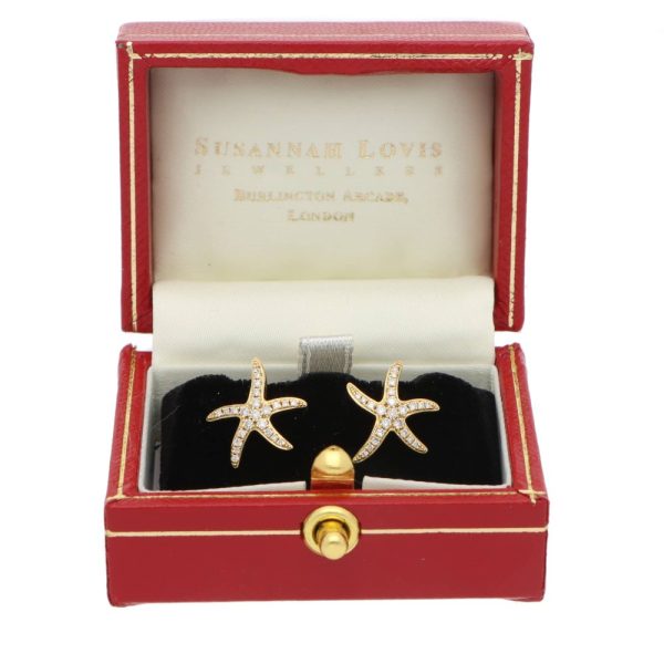 Diamond starfish earrings in yellow gold.