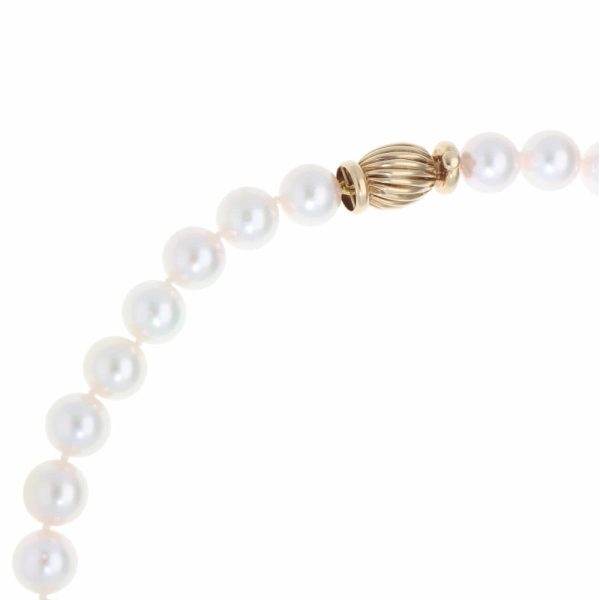 Akoya pearl necklace with a vintage ridged barrel clasp in gold.