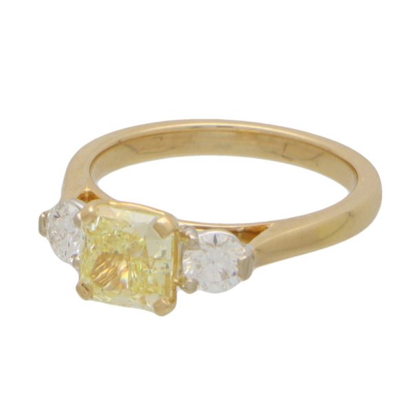 Yellow diamond three stone ring in yellow and white gold.