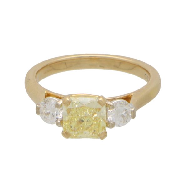 Yellow diamond three stone ring in yellow and white gold.