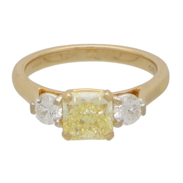 Yellow diamond three stone ring in yellow and white gold.