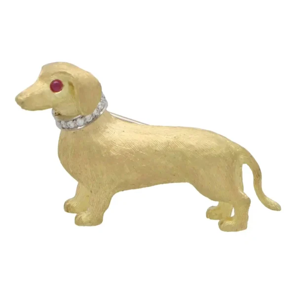 Diamond and ruby Dachshund dog brooch in gold.