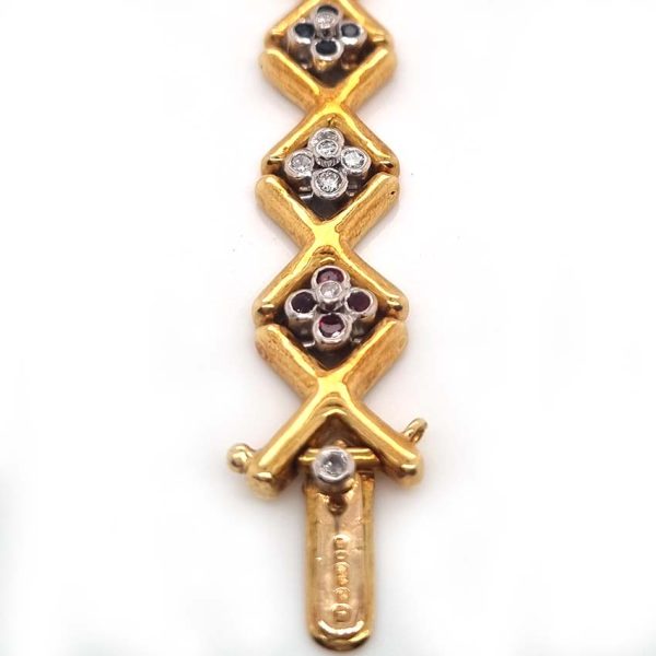 Ruby Emerald Sapphire Diamond Set Gold Bracelet, 18ct yellow gold 'X' design link bracelet accented with clusters of rubies, emerald, sapphires and diamonds