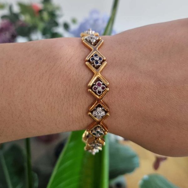Ruby Emerald Sapphire Diamond Set Gold Bracelet, 18ct yellow gold 'X' design link bracelet accented with clusters of rubies, emerald, sapphires and diamonds