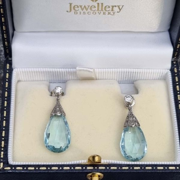 Edwardian Antique 16cts Briolette Aquamarine and Diamond Drop Earrings, Teardrop shaped briolette-cut aquamarine with rose-cut diamond set caps to single stone diamond solitaire tops in platinum. Circa 1910