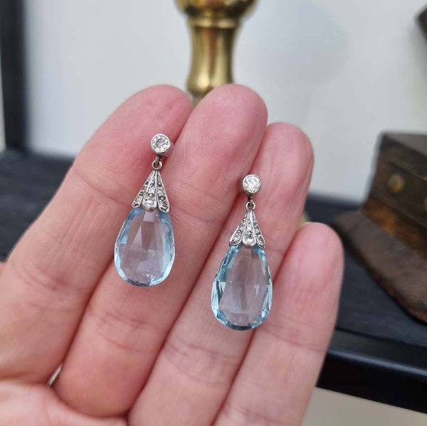 Edwardian Antique 16cts Briolette Aquamarine and Diamond Drop Earrings, Teardrop shaped briolette-cut aquamarine with rose-cut diamond set caps to single stone diamond solitaire tops in platinum. Circa 1910