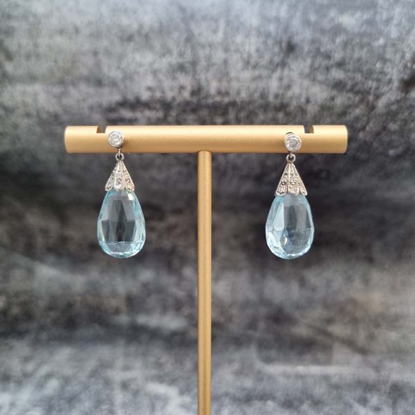 Edwardian Antique 16cts Briolette Aquamarine and Diamond Drop Earrings, Teardrop shaped briolette-cut aquamarine with rose-cut diamond set caps to single stone diamond solitaire tops in platinum. Circa 1910