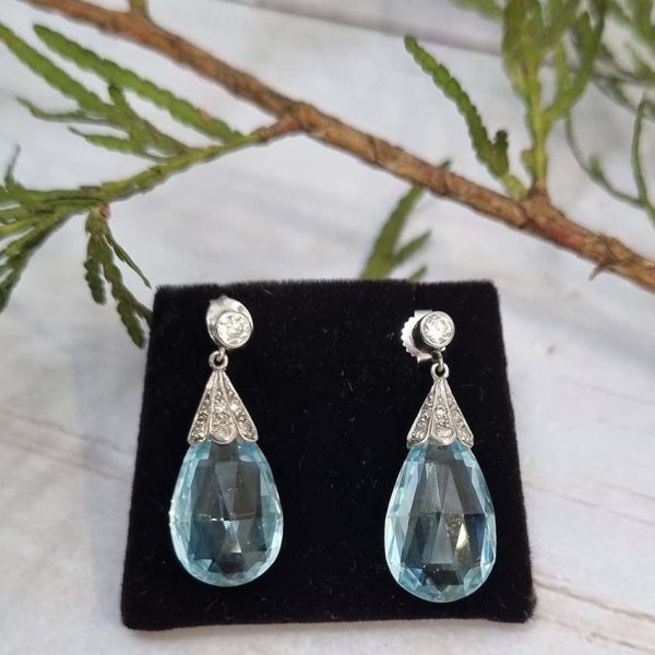 Edwardian Antique 16cts Briolette Aquamarine and Diamond Drop Earrings, Teardrop shaped briolette-cut aquamarine with rose-cut diamond set caps to single stone diamond solitaire tops in platinum. Circa 1910