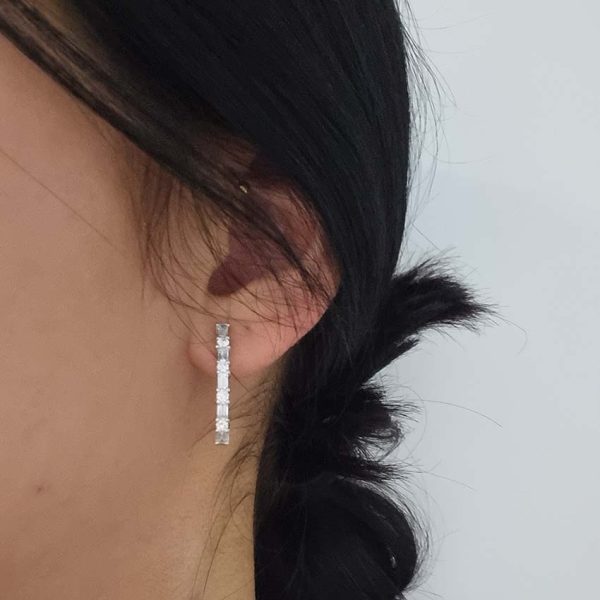 Horseshoe 1.31ct Brilliant and Baguette Diamond Hoop Earrings, 1.31 carats of alternating baguette and round brilliant diamond set horseshoe-shaped hoop earrings in 18ct white gold