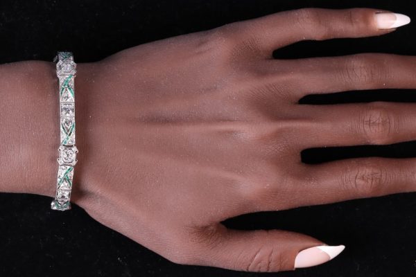 Art Deco platinum bracelet with diamonds and emeralds.
