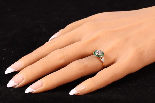 Art Deco diamond and emerald engagement ring in yellow gold and platinum.