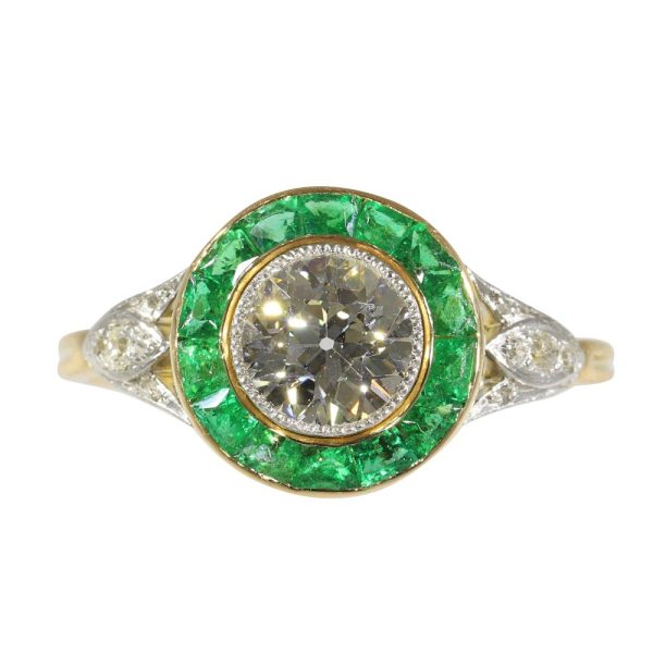 Art Deco diamond and emerald engagement ring in yellow gold and platinum.