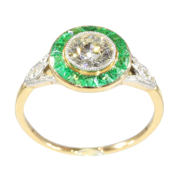 Art Deco diamond and emerald engagement ring in yellow gold and platinum.