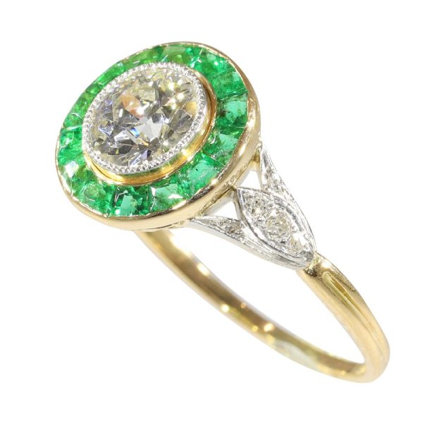 Art Deco diamond and emerald engagement ring in yellow gold and platinum.