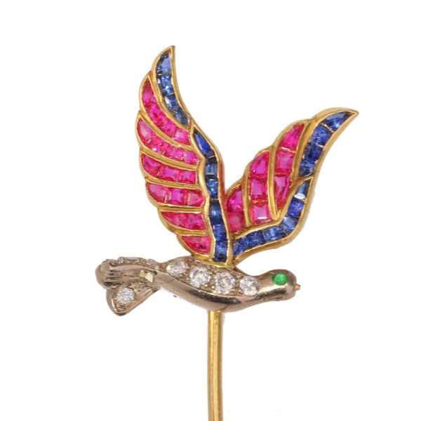 Vintage flying bird tiepin with multiple gemstones in gold.