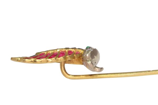 Vintage flying bird tiepin with multiple gemstones in gold.