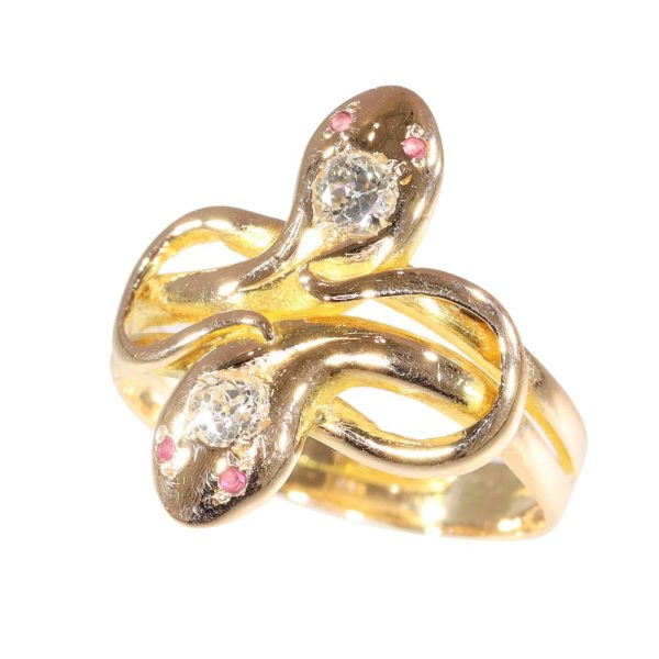 Double snake ring with diamonds and rubies in gold.
