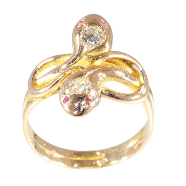 Double snake ring with diamonds and rubies in gold.