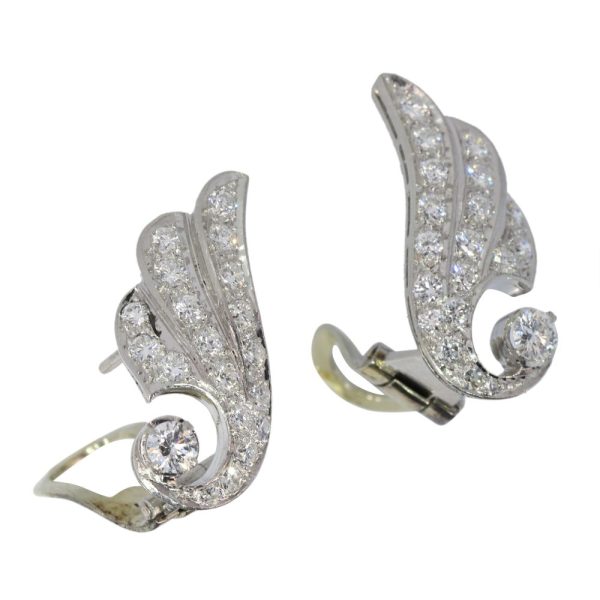 Diamond wing earrings in platinum.