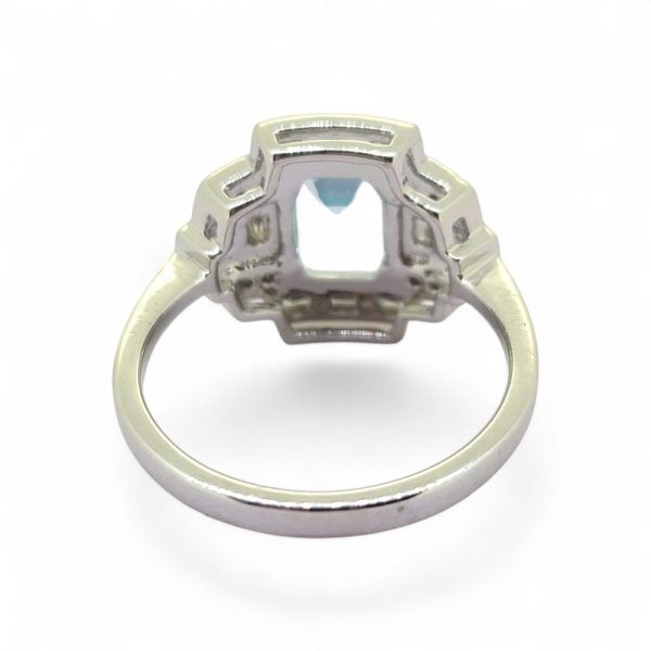 2ct Aquamarine and Diamond Cluster Dress Ring, 2.11ct emerald-cut aquamarine surrounded by brilliant and baguette-cut diamonds in geometric design in 18ct white gold