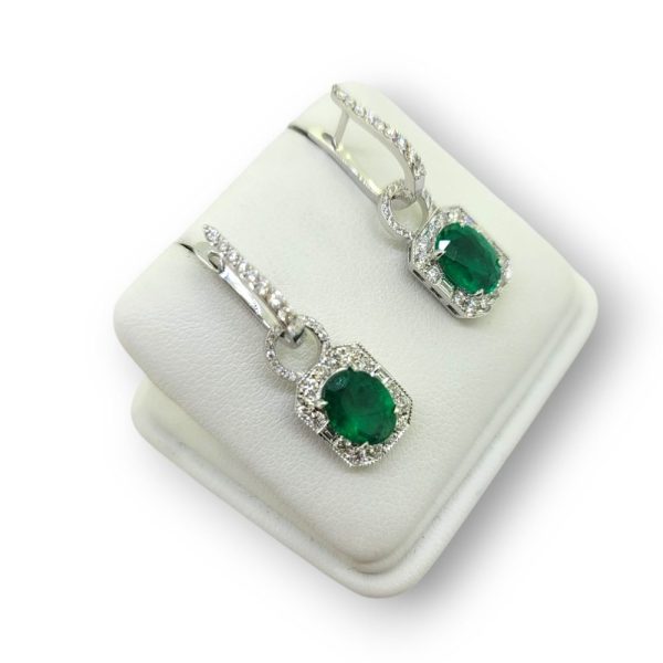 Contemporary 3.16ct Oval Emerald and Diamond Cluster Drop Earrings in 18ct White Gold, oval and diamond clusters suspended from horseshoe shaped diamond tops that can be worn with or without the drop