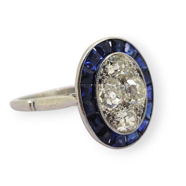 Vintage Sapphire and Diamond Oval Target Cluster Engagement Ring in Platinum, oval cluster of old-cut diamonds with outer border of calibre sapphires
