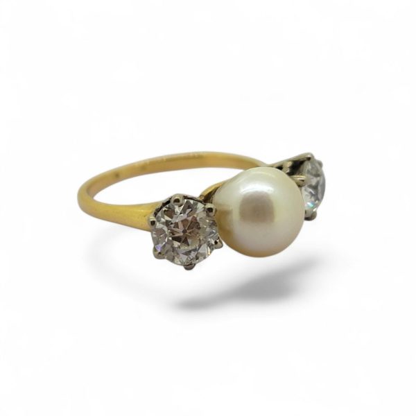 Old Cut Diamond and Pearl Three Stone Engagement Ring, central pearl flanked by 1ct old-cut diamonds in 18ct yellow gold