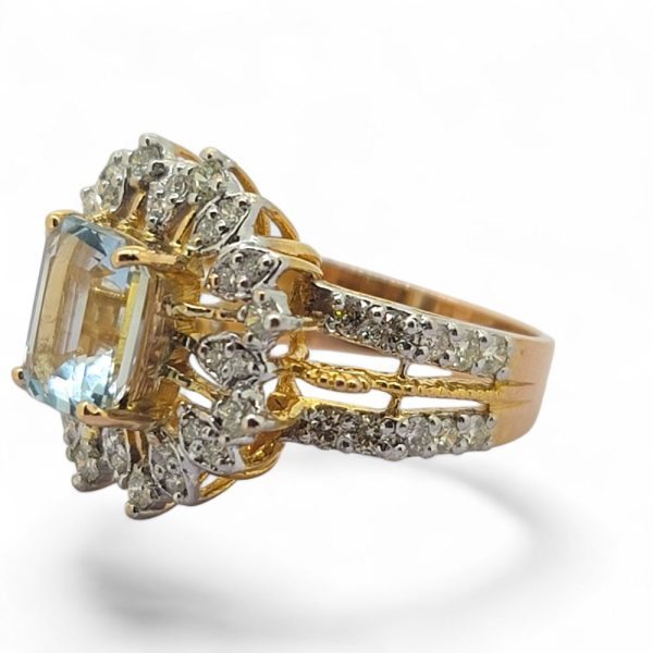 Aquamarine and diamond cluster dress ring in 21 carat yellow gold