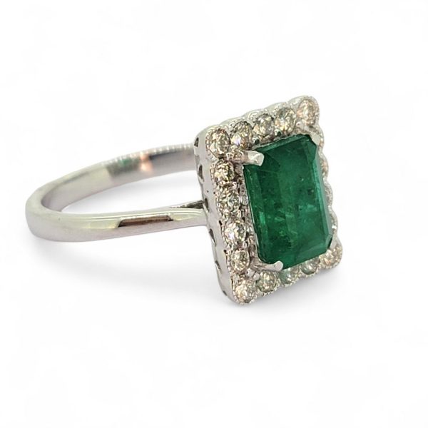 2ct Emerald and Diamond Cluster Engagement Ring, 2.12ct emerald-cut emerald surrounded by rectangular border of sparkling diamonds in 18ct white gold