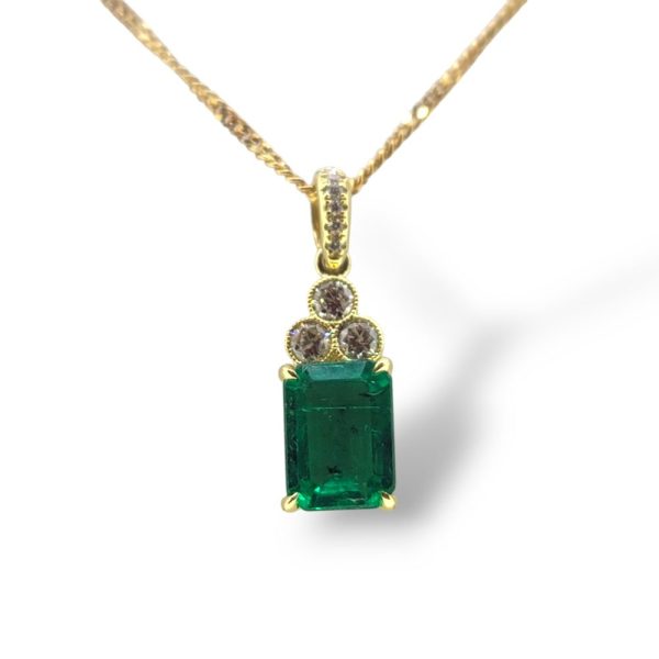 1.72ct Emerald and Diamond Pendant with Chain, 1.72ct emerald-cut emerald suspended from diamond set bail with trio of diamonds set to the head of the emerald in 18ct yellow gold