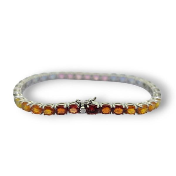 Multi Fancy Colour Rainbow Sapphire Line Bracelet, 16.10 carats of oval-cut pink sapphires, blue sapphires, green sapphire, yellow sapphires and orange sapphires in 18ct white gold
