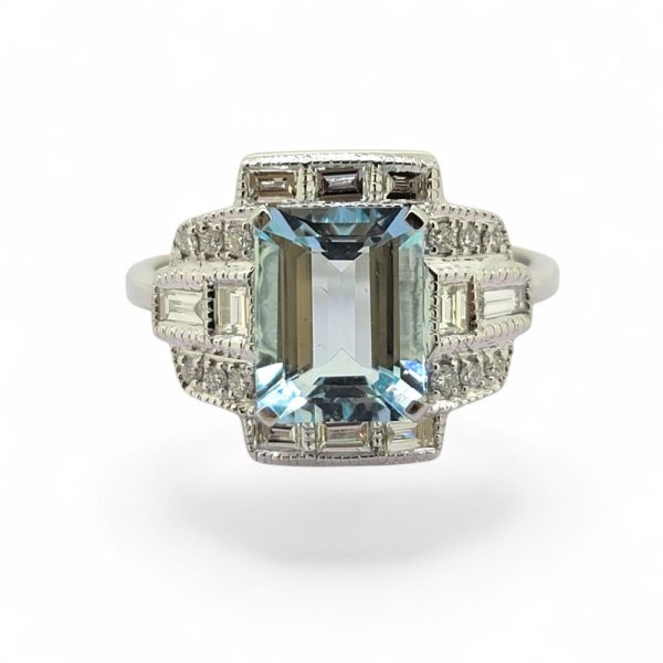 2ct Aquamarine and Diamond Cluster Dress Ring, 2.11ct emerald-cut aquamarine surrounded by brilliant and baguette-cut diamonds in geometric design in 18ct white gold