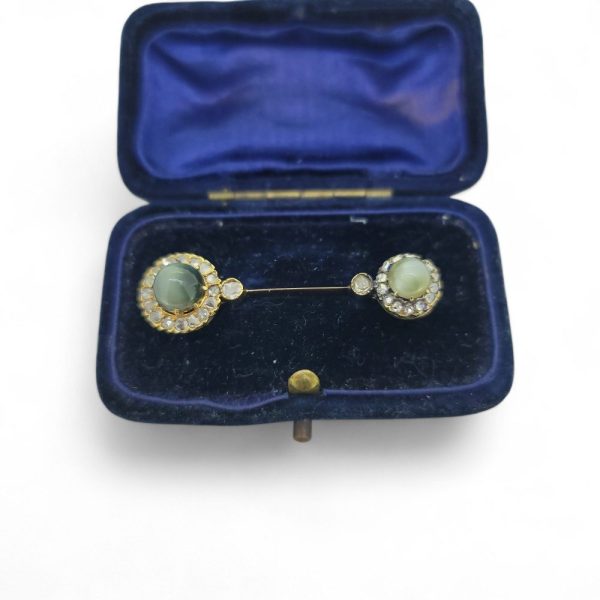 Antique Diamond and Cats Eye Chrysoberyl Pin Brooch, decorated with a cat's eye chrysoberyl and diamond cluster to each end. Presented in fitted box.