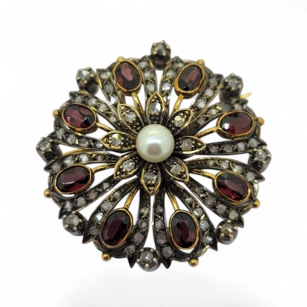Antique Garnet Pearl and Diamond Pendant Brooch, circular pierced design pendant-come-brooch central pearl surrounded by oval garnets on diamond studded mount in silver upon gold