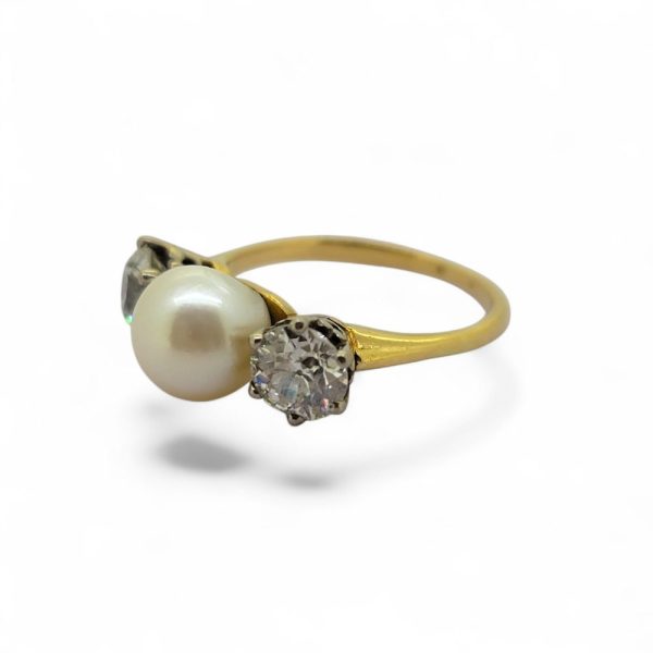 Old Cut Diamond and Pearl Three Stone Engagement Ring, central pearl flanked by 1ct old-cut diamonds in 18ct yellow gold
