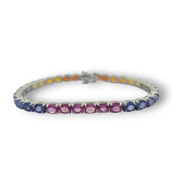 Multi Fancy Colour Rainbow Sapphire Line Bracelet, 16.10 carats of oval-cut pink sapphires, blue sapphires, green sapphire, yellow sapphires and orange sapphires in 18ct white gold