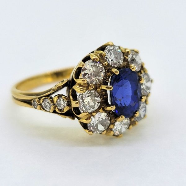 Antique Style 1.70ct Sapphire and Diamond Cluster Engagement Ring, 1.50ct oval cut sapphire surrounded by 1.40cts diamonds in crown cluster setting in 18ct yellow gold