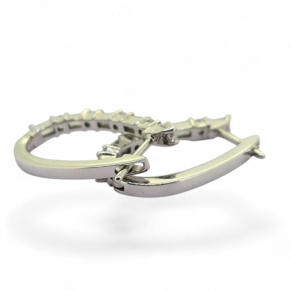 Horseshoe 1.31ct Brilliant and Baguette Diamond Hoop Earrings, 1.31 carats of alternating baguette and round brilliant diamond set horseshoe-shaped hoop earrings in 18ct white gold