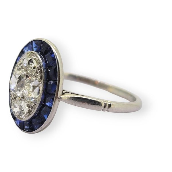 Vintage Sapphire and Diamond Oval Target Cluster Engagement Ring in Platinum, oval cluster of old-cut diamonds with outer border of calibre sapphires