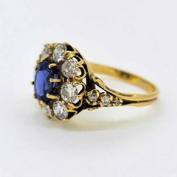 Antique Style 1.70ct Sapphire and Diamond Cluster Engagement Ring, 1.50ct oval cut sapphire surrounded by 1.40cts diamonds in crown cluster setting in 18ct yellow gold