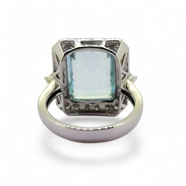 7.40ct Emerald Cut Aquamarine and Diamond Cluster Ring, 7.40 carat emerald-cut aquamarine within sparkling brilliant-cut diamond border in 18ct white gold