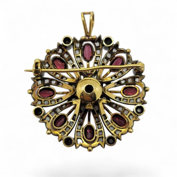 Antique Garnet Pearl and Diamond Pendant Brooch, circular pierced design pendant-come-brooch central pearl surrounded by oval garnets on diamond studded mount in silver upon gold