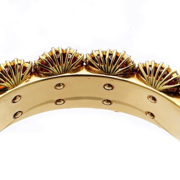 Ruby and diamond bangle in 14 carat gold.